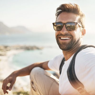 Cropped portrait of a handsome young man taking selfies while hiking in the mountains.